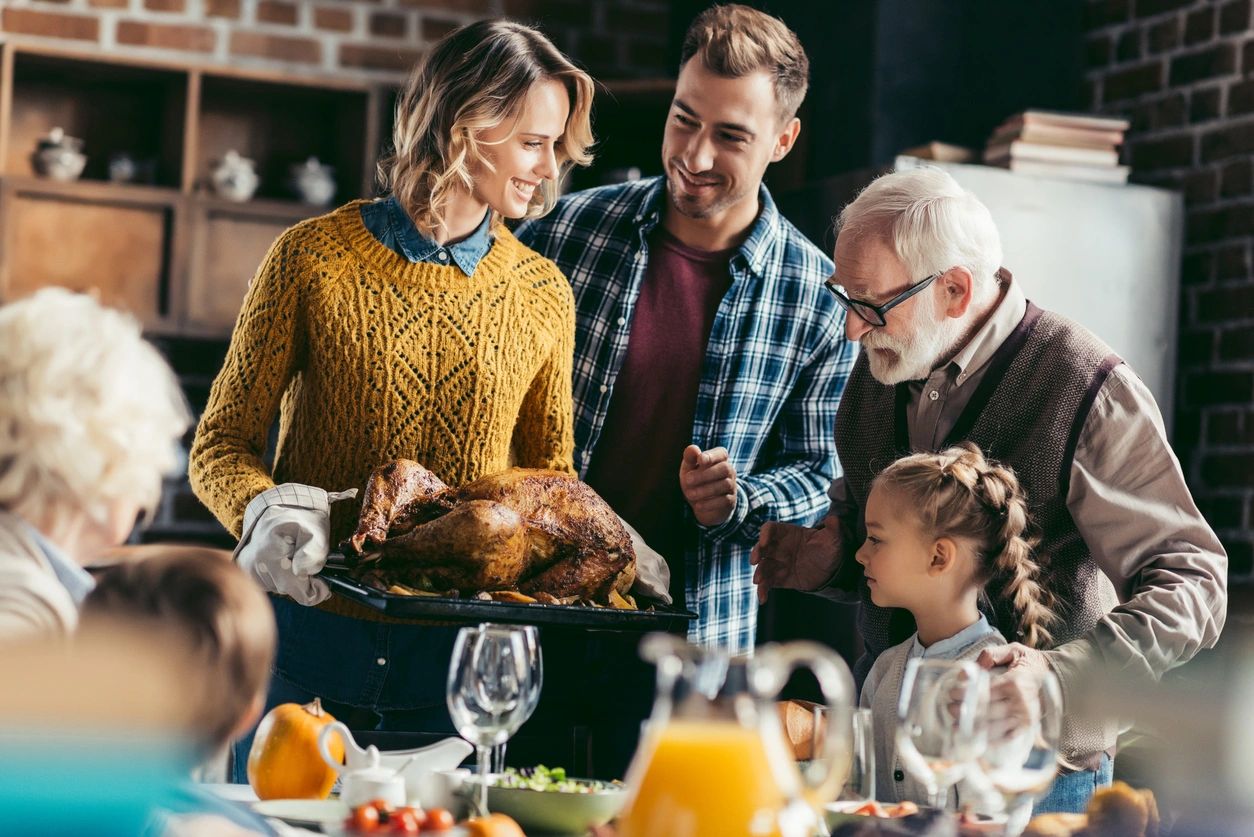 Multiple generations of a family enjoying a meal together.